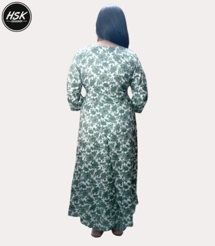 Elevate your ethnic wardrobe with this stunning full-length kurti dress in a sophisticated green and white floral print. The dress features exquisite white lace detailing along the V-neckline, creating an elegant contrast against the verdant floral pattern. The full-length silhouette offers graceful movement, while the long sleeves with gathered cuffs add a touch of vintage charm. The traditional design is beautifully modernised with intricate geometric patterns adorning the neckline and hem. Crafted with attention to detail, this kurti dress combines comfort with style, making it perfect for festive occasions or formal events. The white base with sage green floral motifs creates a fresh, timeless appeal. The dress includes delicate embellishments and can be paired with matching bottoms for a complete ensemble. The flowing silhouette ensures comfort throughout the day while maintaining a sophisticated appearance.